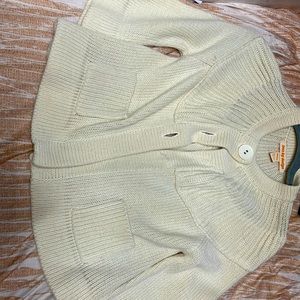 This coat is a small one for children and is cream colored 2buttons have fallen